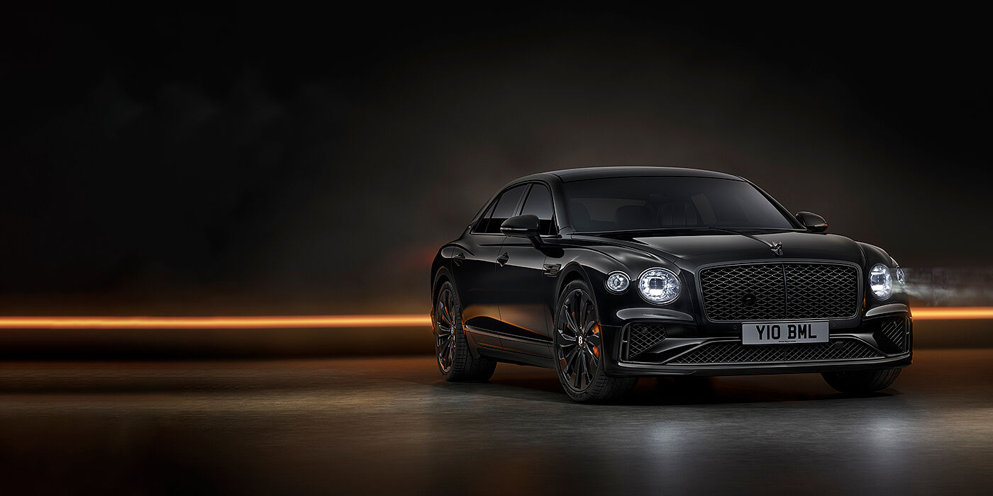 Bentley Glasgow Bentley Flying Spur Black Edition sedan in Black Crystal paint against a dark grey and copper coloured background