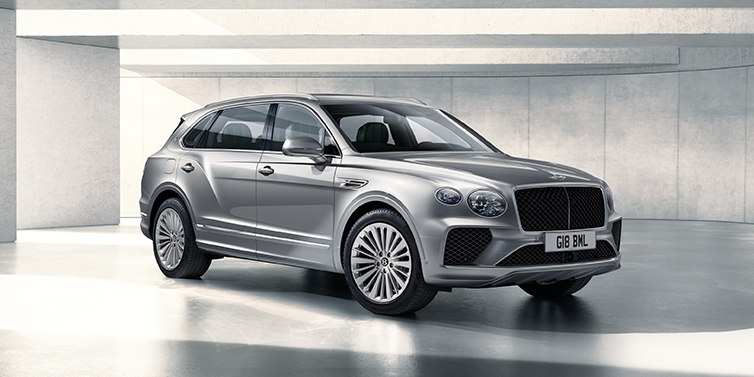 Bentley Glasgow Bentley Bentayga Extended Wheelbase SUV front three quarter in Moonbeam paint with a grey background