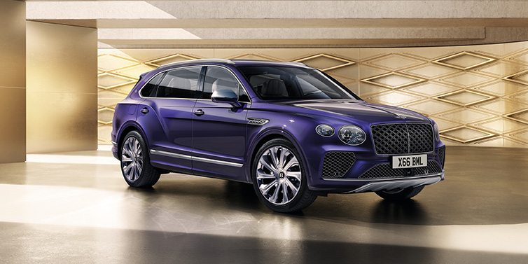 Bentley Glasgow Bentley Bentayga Extended Wheelbase Mulliner SUV front three quarter in Tanzanite Purple paint with a gold patterned background