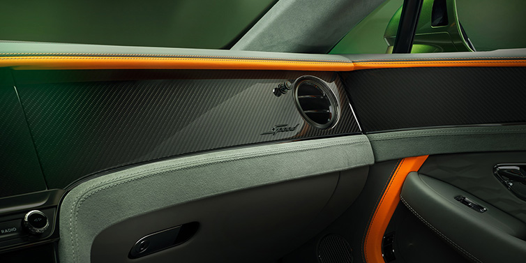 Bentley Glasgow Bentley Continental GT Speed coupe front interior dash detail with high gloss carbon fibre veneer surrounded by Mandarin by Mulliner and Gravity Grey hides