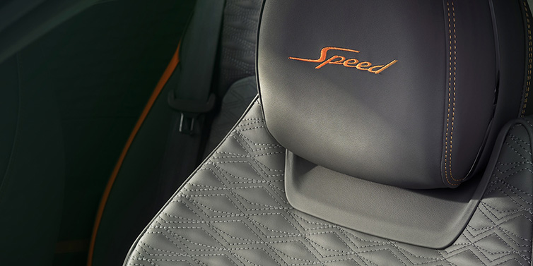 Bentley Glasgow Bentley Continental GT Speed coupe seat detail in Gravity Grey hide and Speed emblem in Mandarin by Mulliner coloured embroidery