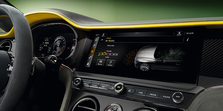 Bentley Glasgow Bentley Continental GTC Speed convertible front interior centre console with MMI screen showing Air Quality visualisation surrounded by Cyber Yellow by Mulliner and Gravity Grey hides and high gloss carbon fibre veneer